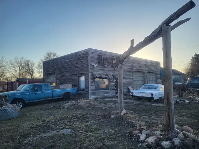 Old weathered garage building with vintage vehicles