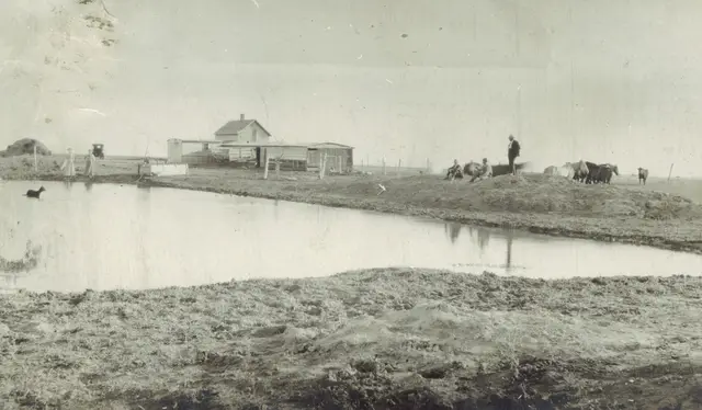 Farmstead and slough with horses and people